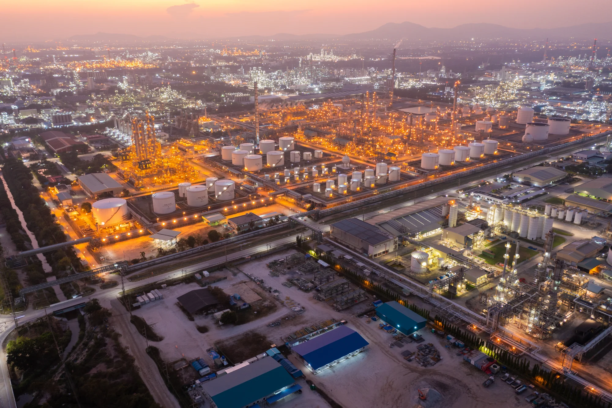Aerial view of an industrial complex at dusk — illustrative image
